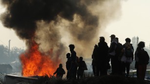 Migrants torch huts in Calais camp