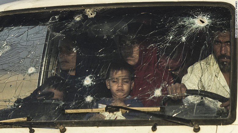 Iraqi families displaced by fighting between Iraqi forces and ISIS flee their home near Mosul on Saturday.