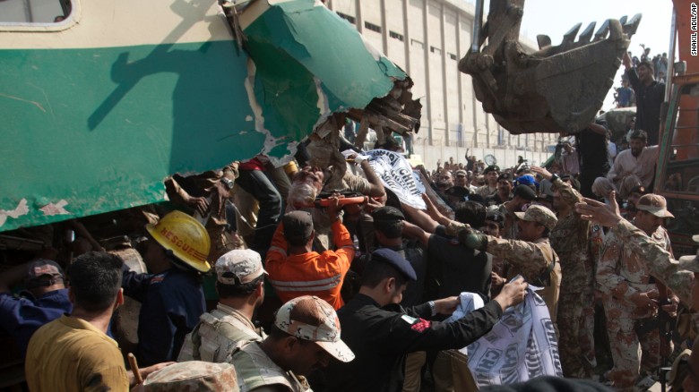 People remove an injured passenger from the train wreck, Thursday, November 3, 2016.