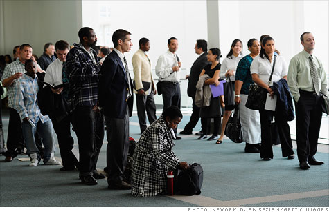 Job seekers look for employment at a career fair In Los Angeles.