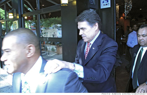 Gov. Rick Perry of Texas followed supporter Fernando Mateo out of his wife's restaurant in a quick visit to New York City.