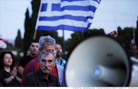 Taxi drivers protest outside the Greek Parliament in the center of Athens as the government struggles to cut spending and raise taxes.