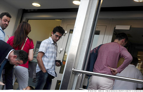 Bank customers in Greece, lining up recently at an ATM, have made widespread withdrawals of cash.