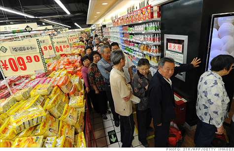 Chinese shoppers lining up to buy discounted eggs at a supermarket.