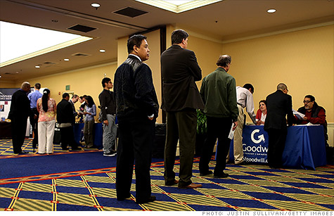 Job seekers attend a career fair in San Francisco. Unemployment claims rose last week.