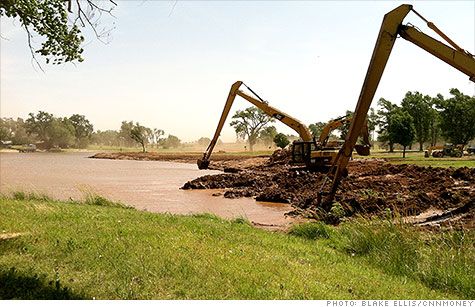 Excavators prepare water for the oil industry in Kansas. The drought is restricting water available for fracking, which could harm U.S. oil production.
