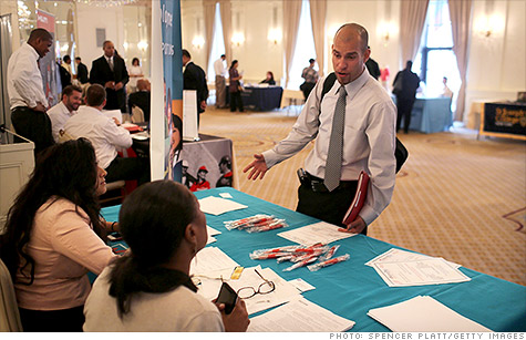 A job applicant speaks to perspective employers at a career fair in New York last week.