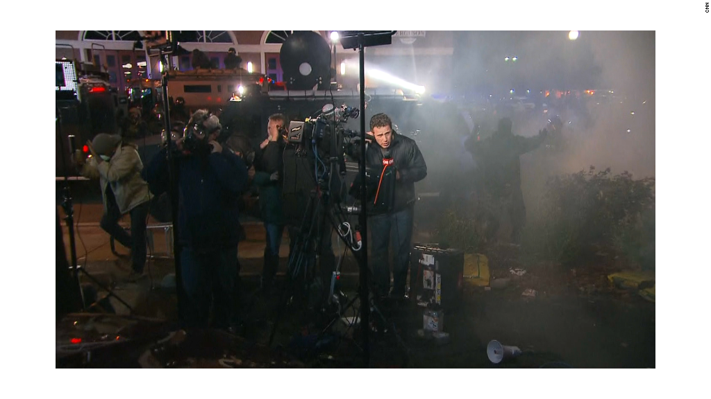 Ferguson reporters hit with tear gas, rocks