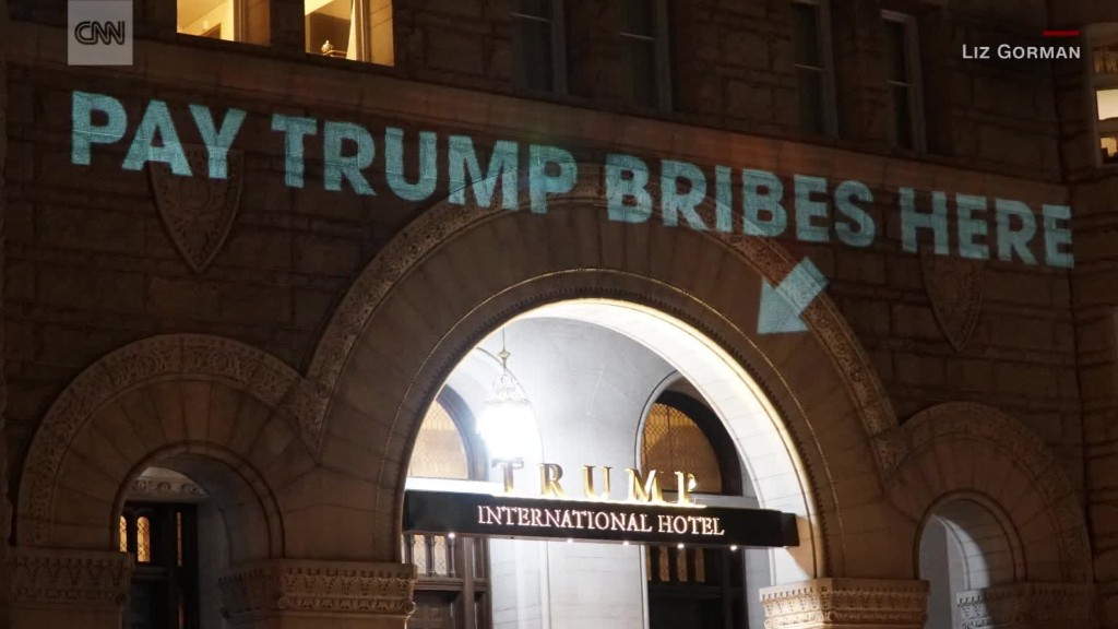'Pay bribes here' projected onto Trump's hotel