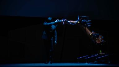 Engineer dances onstage with robot he programmed
