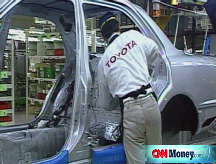 Toyota slashes profits